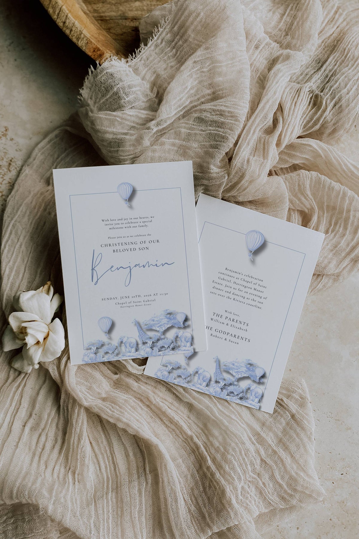 Wedding invitation cards with decorative elements on a textured fabric background