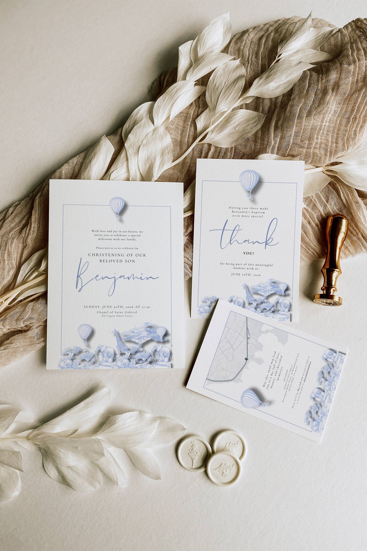 Wedding invitation set with floral elements on a neutral background